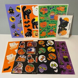 May include: A set of 10 Halloween themed sticker sheets featuring various images of pumpkins, ghosts, bats, witches, and cats. The stickers are colorful and have a cartoonish style. The sheets are printed on white paper and have a glossy finish.