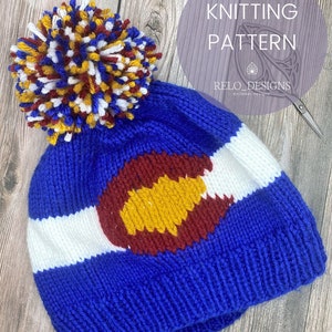 May include: Knitting pattern for a blue, white, red, and yellow beanie with a pom pom. The beanie features the Colorado state flag design. The pattern is by Relo Designs.