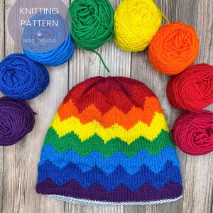 May include: A rainbow knit hat with a chevron pattern. The hat is surrounded by balls of yarn in the colours of the rainbow.