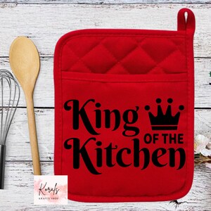 May include: Red quilted oven mitt with a black graphic that says "King of the Kitchen" with a crown above the word "King".