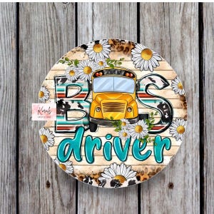 May include: A round wooden sign with a yellow school bus, white daisies, and the words "Bus Driver" in turquoise lettering. The sign has a rustic wood background with a cowhide pattern and a leopard print border.
