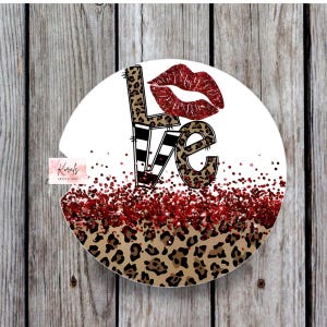 May include: Round coaster with a white background and a red glitter design. The word "LOVE" is written in black and white stripes with leopard print accents. A red glitter lip print is above the word "LOVE".
