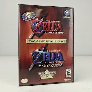 May include: The Legend of Zelda: Ocarina of Time video game for Nintendo GameCube. The game case features the game title, a shield and sword graphic, and the text "Two-Game Bonus Disc!" and "Master Quest". Includes a "1998 Game of the Year" sticker.
