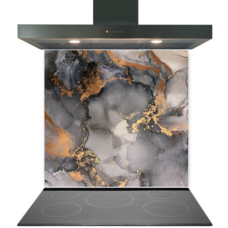 May include: A kitchen backsplash with a modern abstract design featuring gray and gold marble-like swirls. The backsplash is installed behind a stainless steel range hood with a black glass cooktop.