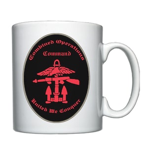 May include: White ceramic mug with a black and red graphic of the Combined Operations Command logo. The logo features a red eagle with wings spread, holding a rifle, and an anchor with three arrows. The text around the logo reads "Combined Operations Command" and "United We Conquer".
