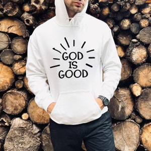 May include: White hooded sweatshirt with a black graphic that says "GOD IS GOOD" with radiating lines around the text.