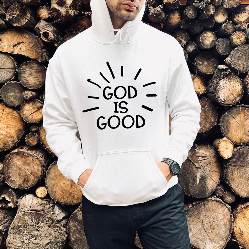 May include: White hooded sweatshirt with a black graphic that says "GOD IS GOOD" with radiating lines around the text.