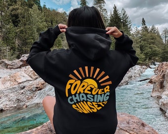 May include: Black hooded sweatshirt with a graphic print of a sun and the text "FOREVER CHASING SUNSETS".