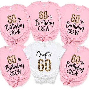 May include: Six pink t-shirts with black text that reads "60th Birthday Crew" and a leopard print number 60. One white t-shirt with black text that reads "Chapter 60" and a leopard print number 60.