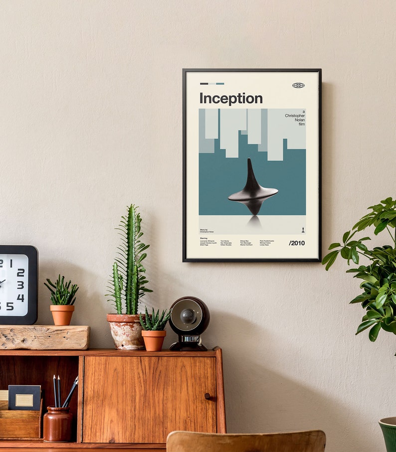 May include: A black framed poster with a minimalist design featuring the title "Inception" in white text. The poster also includes the name "Christopher Nolan Film" and the year "2010". The poster features a spinning top, a key element from the film.