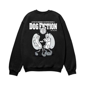 May include: Black sweatshirt with the text "DOG FICTION" and a cartoon illustration of two hot dogs. The phrase "HOT DOGS! THE CORNERSTONE OF ANY NUTRITIOUS BREAKFAST" is above the main text. A "a Hot Dog film" is below the main text.
