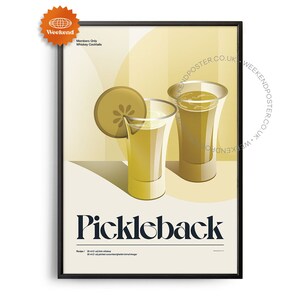 May include: A vintage-style poster with a black frame advertising a cocktail called "Pickleback". The poster features a yellow background with two shot glasses filled with a yellow liquid and a slice of pickle. The text "Pickleback" is in a bold, black font.
