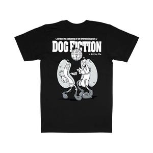 May include: Black t-shirt featuring a cartoon illustration of two hot dogs with arms and legs, dancing. The text "DOG FICTION" is displayed in bold white letters above the hot dogs. The phrase "HOT DOGS! THE CORNERSTONE OF ANY NUTRITIOUS BREAKFAST" is above the title.