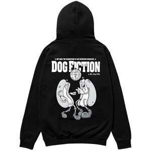 May include: Black hooded sweatshirt featuring a cartoon graphic of two hot dogs holding a disco ball. The text "DOG FICTION" is above the graphic, with the phrase "HOT DOGS! THE CORNERSTONE OF ANY NUTRITIOUS BREAKFAST." above the text.