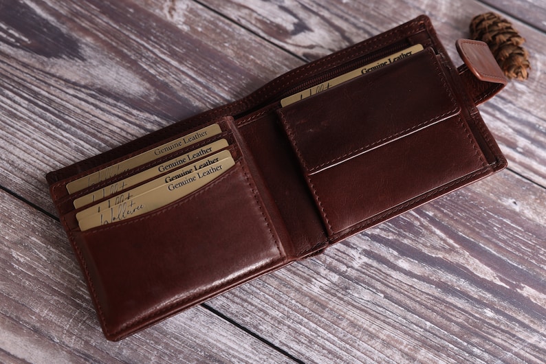 May include: A brown leather wallet with multiple card slots and a flap closure. The wallet has the words "Genuine Leather" printed on the inside.