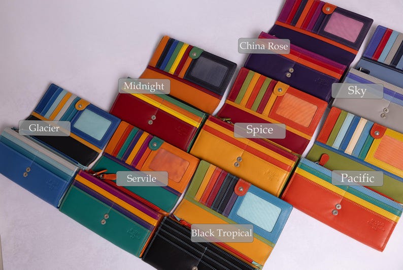 May include: A collection of ten colorful leather wallets with different patterns and names, including Glacier, Midnight, Servile, Black Tropical, Spice, China Rose, Sky, Pacific.