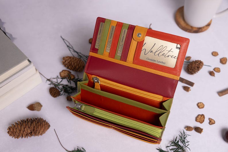May include: A multi-colored leather wallet with a zipper closure and multiple card slots. The wallet is open and the inside is lined with a green fabric. The brand name "Walletree Genuine Leather" is visible on the inside of the wallet.