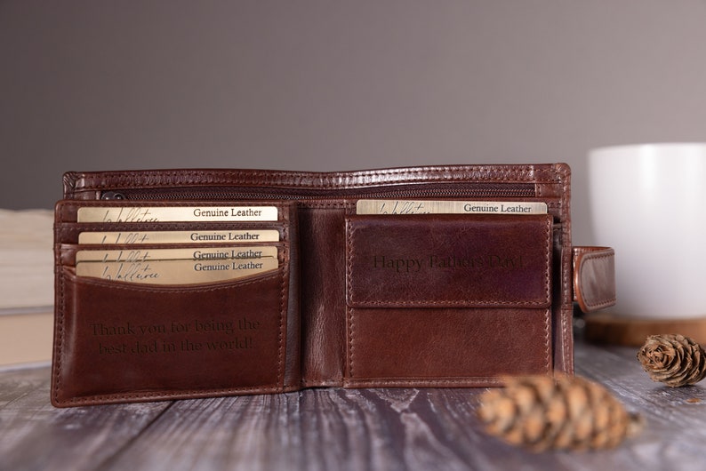May include: Brown leather wallet with multiple card slots and a zippered compartment. The wallet is open and has the text "Genuine Leather" and "Happy Father's Day!" engraved on the inside.