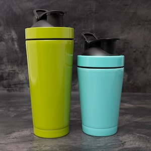 May include: Two stainless steel shaker bottles with black lids and handles. The larger bottle is green and the smaller bottle is blue.