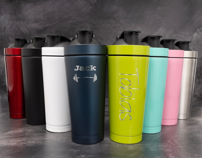 May include: Eight stainless steel shaker bottles with different coloured lids and personalised engravings. The engravings include the names "Jack" and "Tobias" and a dumbbell symbol.