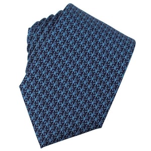 May include: A navy blue tie with a repeating light blue pattern. The tie is folded, showcasing the intricate design. The pattern appears to be a stylized cross or symbol, creating a classic and elegant accessory.