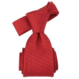 May include: A red tie with a repeating geometric pattern. The tie is knotted, showcasing its design and texture. The color is a vibrant, solid red, suitable for formal or business attire.