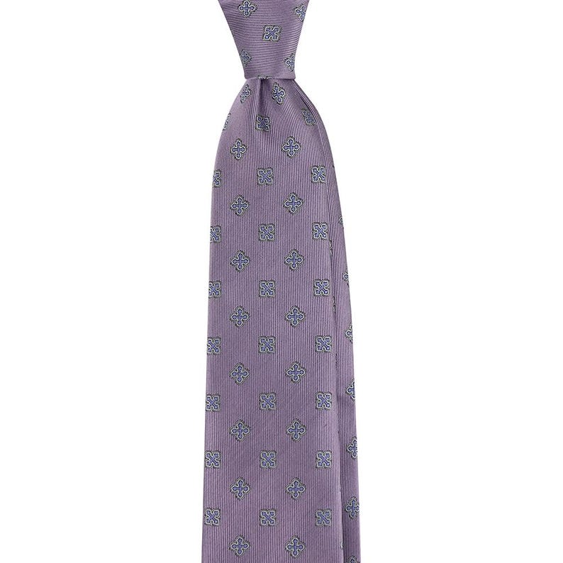 May include: A purple silk tie with a blue and white geometric pattern.
