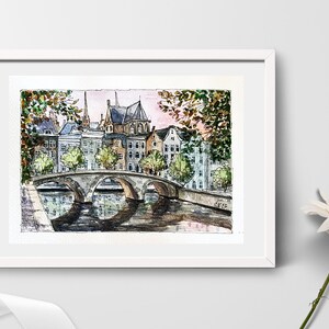 May include: Watercolor painting of a bridge over a canal in a European city. The buildings are in the background, and there are trees on either side of the bridge. The water is reflecting the sky and the buildings.