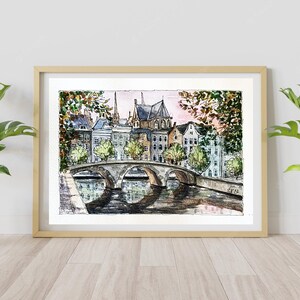 May include: Watercolor painting of a bridge over a canal in a European city. The bridge is made of stone and has arches. There are buildings on both sides of the canal, and trees lining the banks. The sky is a soft pink and blue.