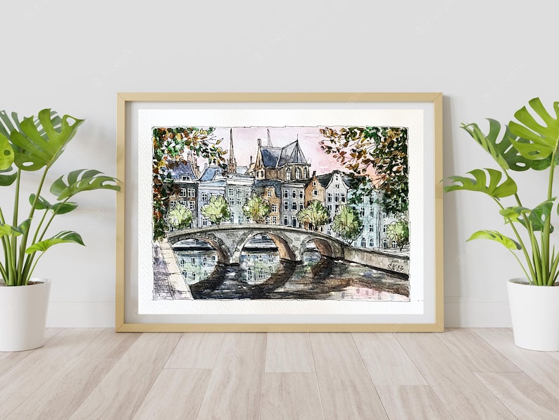 May include: Watercolor painting of a bridge over a canal in a European city. The bridge is made of stone and has arches. There are buildings on both sides of the canal, and trees lining the banks. The sky is a soft pink and blue.