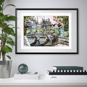 May include: Watercolor painting of a bridge over a canal in a European city. The painting features buildings with red tile roofs, trees, and a reflection of the bridge in the water.
