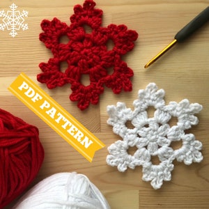 May include: Two crocheted snowflakes, one red and one white, on a wooden surface. The text "PDF PATTERN" is visible in the image.