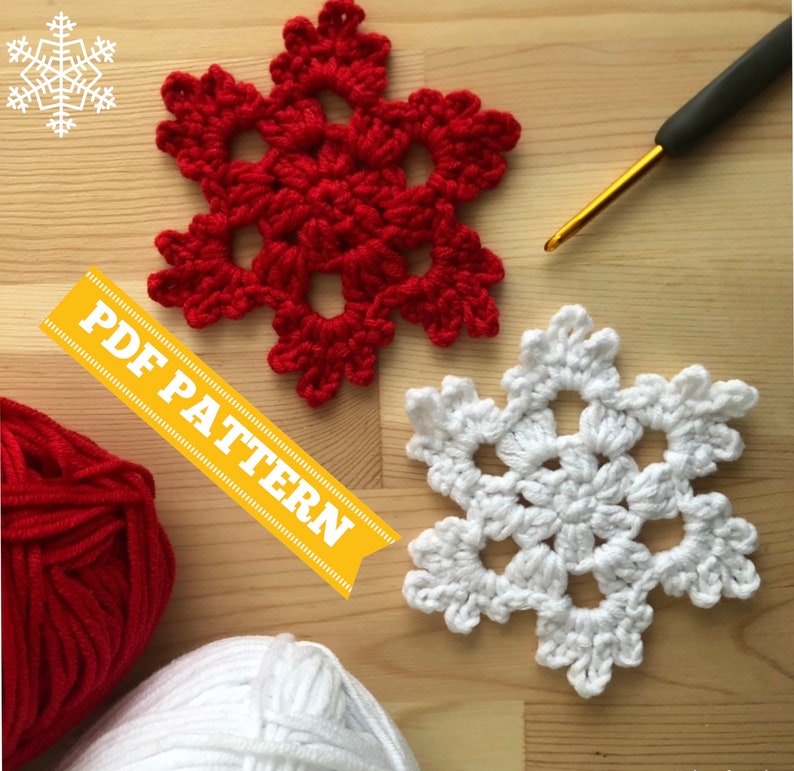 May include: Two crocheted snowflakes, one red and one white, on a wooden surface. The text "PDF PATTERN" is visible in the image.