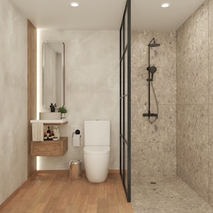 May include: A modern bathroom with a white toilet, a sink with a wooden vanity, and a glass shower stall with a black shower head.
