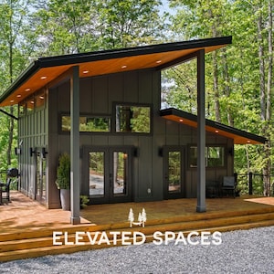 May include: A modern cabin with dark gray vertical siding, a slanted roof with wood-toned soffits, and large glass doors. A wooden deck surrounds the structure, featuring outdoor furniture and recessed lighting, set against a lush forest background.
