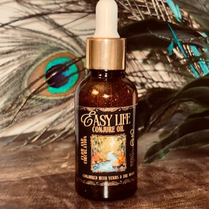 May include: A brown glass dropper bottle labeled Easy Life Conjure Oil. The label features a forest stream illustration, the text Flow and Circulation, and the phrase Conjured with Venus & the Moon, along with planetary and lunar symbols.