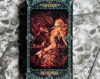 May include: A tarot card with a dark illustration of a woman and a dragon, with the words "Blood Bound" and "The Lovers." The card is set against a background of skull-themed cards.
