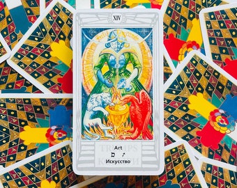 May include: A tarot card with a white background and a silver border. The card is numbered XIV and the word "Art" is written in the center of the card. The card depicts a woman in a green dress holding a white dove and a red bird. The woman is surrounded by a circle of light.