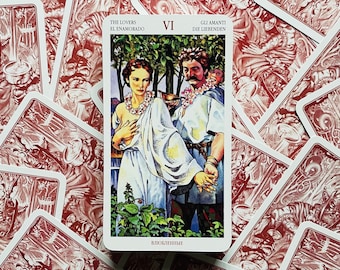 May include: The Lovers tarot card from the Rider-Waite deck. The card depicts a man and woman standing in a garden, with a winged angel above them. The card is numbered VI and has the words "The Lovers", "El Enamorado", "Gli Amanti", and "Die Liebenden" printed on it.