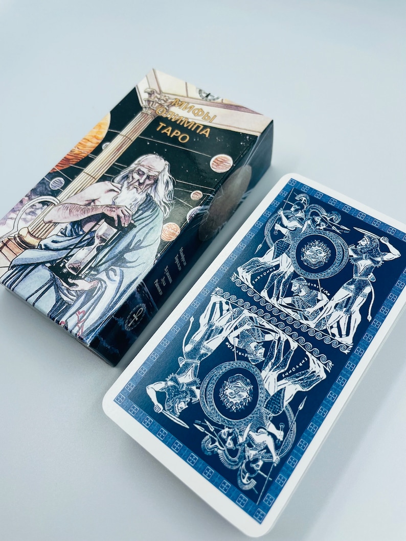 May include: A blue and white tarot card with a depiction of a battle scene. The card is from the "Myths of Olympus Tarot" deck.