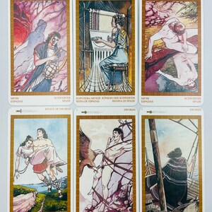 May include: A set of ten tarot cards featuring illustrations of swords. The cards are white with gold borders and feature the words "Swords" and "Queen of Swords".
