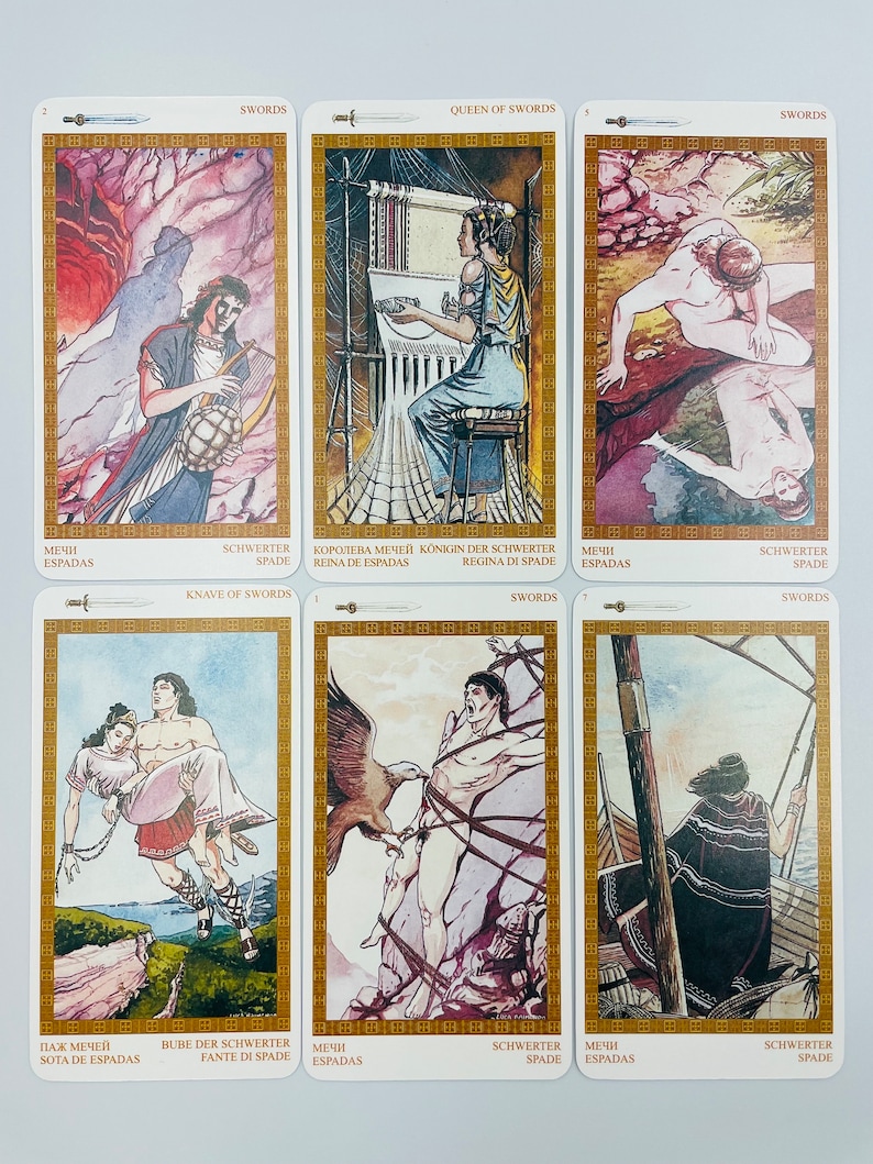 May include: A set of ten tarot cards featuring illustrations of swords. The cards are white with gold borders and feature the words "Swords" and "Queen of Swords".