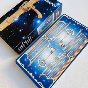 May include: A blue tarot card with a gold keyhole and multiple gold keys on a blue background with stars. The card is titled "Tarot 78 дверей" in Russian.