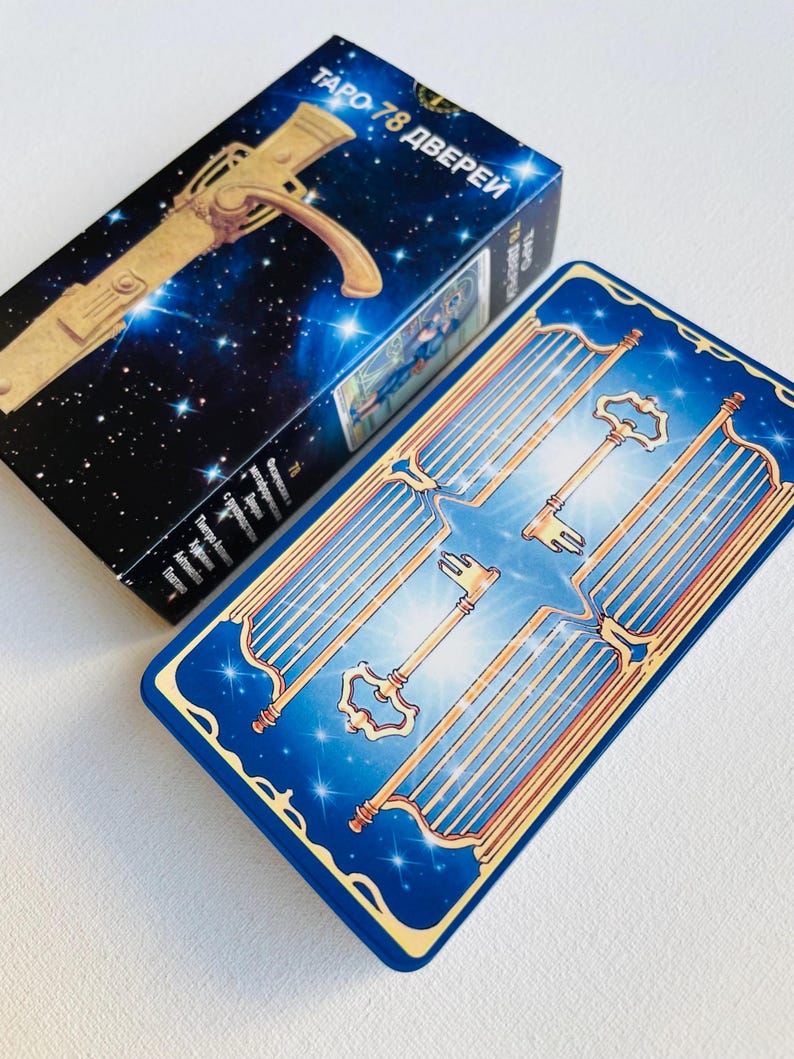 May include: A blue tarot card with a gold keyhole and multiple gold keys on a blue background with stars. The card is titled "Tarot 78 дверей" in Russian.