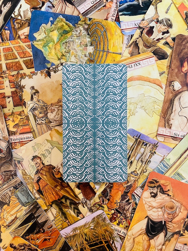 May include: A close-up of a tarot card with a blue and white pattern. The card is surrounded by other tarot cards, including the "Temperance" card, the "Six of Pentacles" card, and the "Fortuna" card.