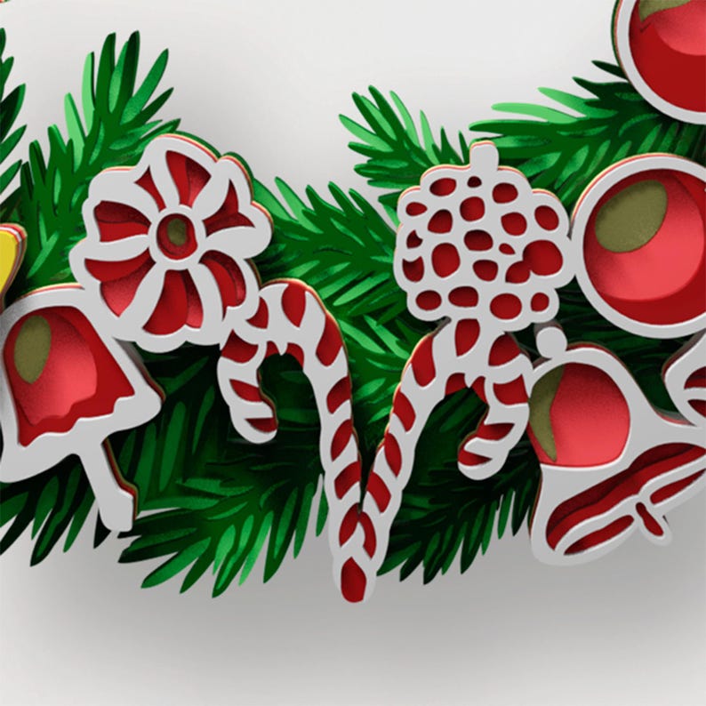 May include: A decorative holiday wreath featuring vibrant green pine needles interspersed with layered white and red ornaments. The ornaments include candy canes, circular floral patterns, bell shapes, and round berries, creating a festive display.