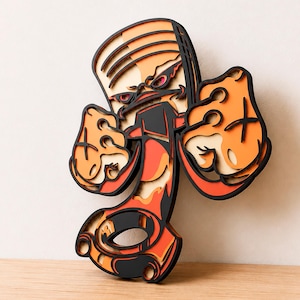 Può includere: Un'opera d'arte da parete in legno a più strati che raffigura un pistone del motore stilizzato con mani in stile cartone animato su entrambi i lati. Il design presenta contorni neri marcati, accenti di colore arancione e rosso e profondità.