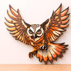 May include: A multi-layered wall art piece depicting an owl in flight with wings spread wide. The design features intricate cutouts and a color palette of dark brown, bright orange, and cream, creating a dimensional effect with stacked layers.