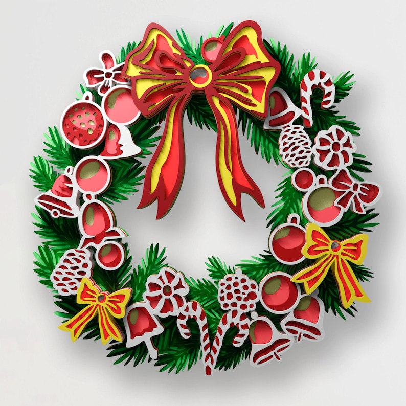 May include: A layered paper-cut style Christmas wreath featuring a large red and yellow bow at the top. The wreath is decorated with red and white ornaments, bells, candy canes, pinecones, and smaller bows against a green pine needle base.