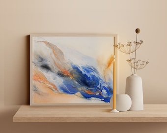 May include: A framed abstract painting with blue, white, and gold hues. The painting is on a wooden shelf with a yellow candle and a white vase with dried flowers.